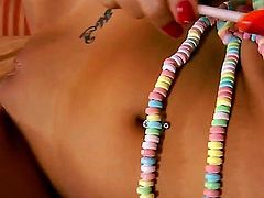 Delicious and tasty bitch Vanessa Veracruz is having fun sucking a colorful candy and using it to please her wet and naughty pussy and also her favorite vibrator for more pleasure.