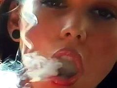 She is quite horny and teasing with her naughty smoking is surely making her hot