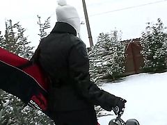 Pretty blonde babe Kathia Nobili with beautiful blue eyes and nice body figure in black warm outfit gets filmed while cleaning snow and having some fun on a winter day.