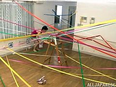 In this strange video a Japanese girl must navigate a ribbon maze in a gym. When she gets to the end of the maze a man picks her up and fingers her extremely hairy vagina until she cums. She moans and screams as she's finger fucked.