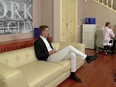 Elegant blonde in snow white blouse and short blue skirt gives unforgettable blowjob to a gentleman on the couch in front of another curious guy. She is good at giving headjob.