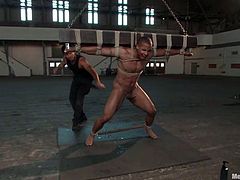 This man named Robert Axel is being tied up and forced to carry that heavy bar on his back. Then he gets suspended so high. BDSM barn is full of gay pain!