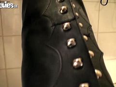 She tall brunette model with long legs and skinny white ass. She strips in the bathroom to put on dirty leather costume. Her slave helps her put on long leather jackboots.