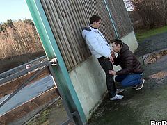 Check out these two twinks! They feel horny and want to have some outdoor action, in public! Without, shameless the guys start getting dirty right there behind that wall. One of them happily kneels for his buddy, opens his mouth and begins to suck cock. His lips slide on that big piece of meat and he craves for cum