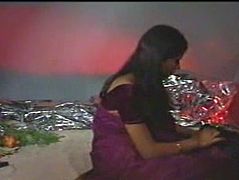 Black haired beauty from Indian looks cute in her purple sari. One guy kisses her big tits and licks her breasts with great pleasure.