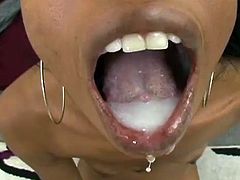 A sexy ebony bitch sucks on a big hard dick and gets a hefty load of cum blasted into her mouth, check it out! It's fucking hot!