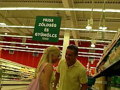 Sex hungry beefy dude picks up a curvy blond MILF in grocery store. He lures her home where he starts mauling her big slack tits from behind before she kneels down to oral fuck his sturdy penis.