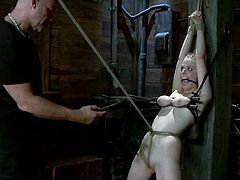 What a hardcore torturing is happening in this BDSM scene. This charming blondie wants more pain and abuse, being hogtied and suspended on the ceiling!