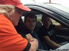 This mature whore works at a gas station. These two young guys picked her up and fucked her holes in an open field.