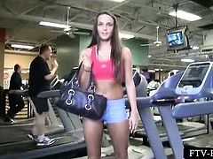 Brunette in tight outfit spreading hot legs at the gym