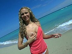 Playful curly blond chic takes a walk at the beach in steamy bikini. Later she shows off her big firm tits that will definitely drive you crazy in sultry sex video by Pornstar.