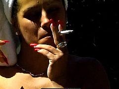 Busty mature loves smoking while acting hot and teasing with her nude body