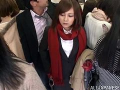 Sexy Japanese chick is getting naughty with some dude in a crowded bus. She makes out with the guy and then allows him to poke his dick deep into her mouth.