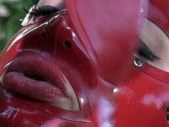 Sextractive BBW woman wearing rubber costume and mask is pleasing her sexual lust outdoor on a loan. Enjoy watching her fingering wet clam passionately.