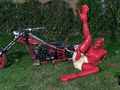Sextractive BBW woman wearing rubber costume and mask is pleasing her sexual lust outdoor on a loan. Enjoy watching her fingering wet clam passionately.