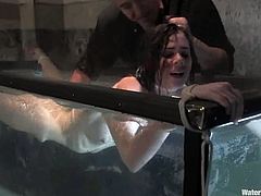 Slim dark-haired chick Isobel Wren allows some guy to bind her in a basement and pour cold water on her small tits and nice shaved pussy.