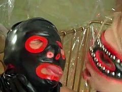 This blonde babe and her lover are both dressed in latex from head to toe. He has a dildo attached to his wrist, which he uses to fuck her pink pussy. He fucks her with his dick too.