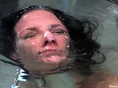 This horny and sizzling brunette lust is a sex slave that loves being immersed in the water tank, being tied up and bondaged!