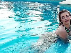 Bosomy Jodie Piper poses beside the pool
