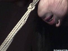 Skinny brunette hussy gets her neck tied to the floor and her hands tied to the ceiling before a sophisticated master pokes her snatch from behind in steamy BDSM sex video by 21 Sextury.