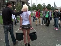Stunning girl from Europe walks in the street with a gag in her mouth. Then she sucks a cock and gets fucked on the steps.