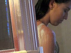 You are going to have a slight glance at the girl soaping her sexy body in the bathroom. The silhouette of her body is observable through the glass door of the shower cabin.