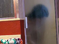 Spy video of seductive brunette girl taking shower in the bathroom