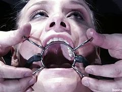 Slim blonde chick with a spider gag in her mouth sits on a chair being tied up. Then she also gets her pussy toyed.