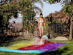 young lesbians play in a slip and slide