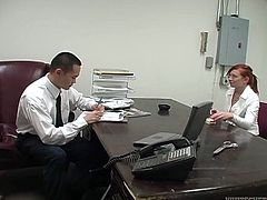 Naughty red haired secretary is about to give her boss steamy blowjob. She unbuttons her blouse and he starts to play with he juicy tits.