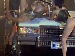 Amazing girls in sexy lingerie have an amazing sex with guy in police uniform on a Lincoln Continental. They suck his big cock and get fucked on a car hood.
