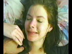 Watch this slutty brunette end up with her face covered by cum after sucking on this guy's hard cock in this vintage clip.