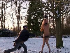 Juicy teen tries to run away from her master on cold snowy day wearing only lingerie. Cutie gets her natural tits rubbed with snow and then gets suspended to the tree outdoors totally naked.