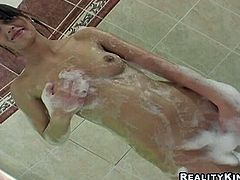 Fantastic brunette girl Demi is having fun while taking a bath. She soaps and strokes her slim body and then fingers her sweet pussy and fucks it with a dildo.