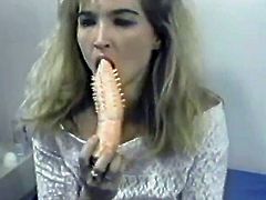 Stunning blonde girl with nice boobs lies on a bed and licks some dildos. After that she toys her vagina and ass at the same time.
