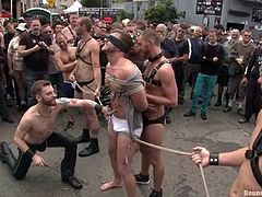 Check this homosexuals dressed up as sadomasochists acting dirty in the middle of the street while people watch them very surprised!