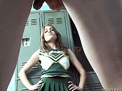 Beautiful brownie in cheerleader uniform drops to her knees and starts to suck a dick in a locker room. This babe also gets jizzed on her tits.