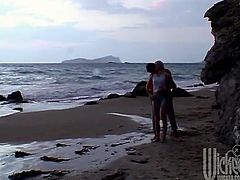 They are walking by the sea and they so that they are alone so they start kissing and taking off clothes before they start fucking like crazy.