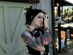 Maegan Machine is a brunette hottie with many tattoos and medium melons. She poses somewhere outdoors, showing her arms, back and booty. She also flashes her boobies.