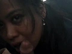 Asian girl sucks dick and swallows cum in a parked car