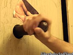 Peter Piper stands on his knees and sucks big black cock with pleasure in glory hole video. He also strokes that dick expertly.