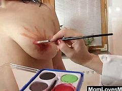 These two have a little fun painting each other's plump bodies then they get out their dildos and pound their pussies until they cum.