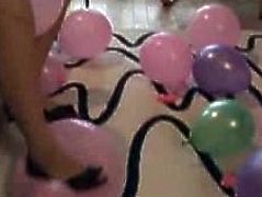 Hot brunette belle plays with balloons