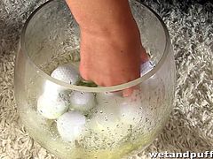 This kinky slut fills a condom up with a bunch of golf balls then inserts it into her wet cunt. She queefs them out one by one into a glass that is laying on the floor. This dirty whore will put anything in her pussy hole, and she even pisses in the glass!