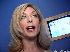 Salacious blonde mom Nina Hartley is a very experienced porn star, and she's gonna share her special skills in this clip. She sucks and rubs a black dick sticking out of a gloryhole and manages to milk it dry.