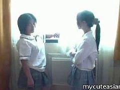 They are a pair of barely legal Asian cuties and they are wearing their schoolgirl outfits for this scene. They get together in front of the camera and start to play.