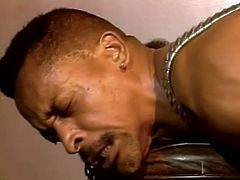Two horny black homosexuals are having a good time together. One of the dudes sucks the other one's prick through a gloryhole and then lets him bang his asshole from behind.