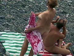 Watching her nude forms while mature lady enjoys the sun is causing voyeur a lot of pleasure