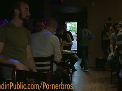 Hot bold hunk is tied up and forced to suck cock in a bar full of horny men. The guy is bound in public and you can't miss it!