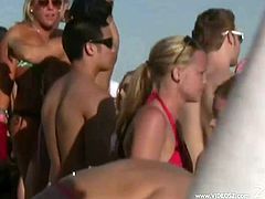 A group of people are having an outdoor party. They dance and have fun and then some of the bitches strip and demonstrate their tits.